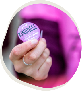 Hand holding a Kindness Pin